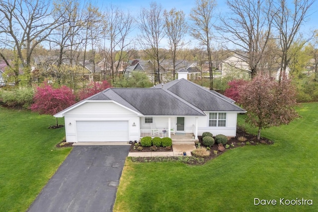 ranch-style home featuring an attached garage, covered porch, asphalt driveway, a front lawn, and roof with shingles