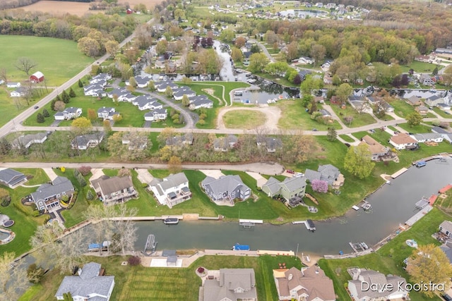 aerial view of property's location featuring a nearby body of water and nearby suburban area