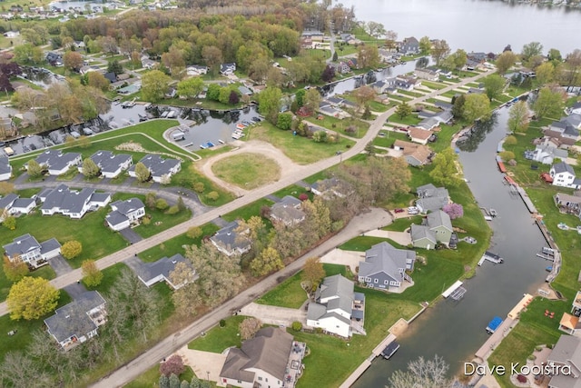 aerial view of property's location featuring nearby suburban area and a large body of water