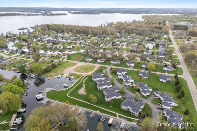 aerial view of property's location featuring a large body of water and nearby suburban area