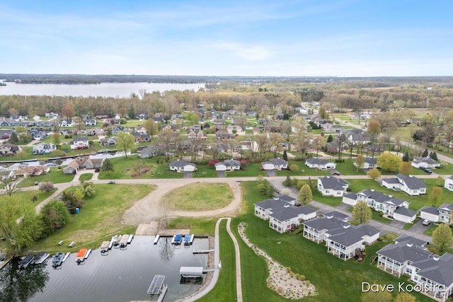 aerial view of residential area featuring a large body of water
