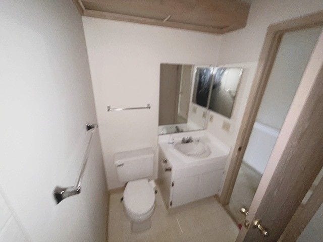 bathroom featuring a sink, toilet, and tile patterned flooring