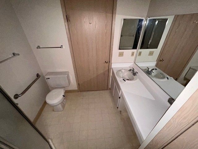 bathroom with vanity, toilet, and tile patterned floors