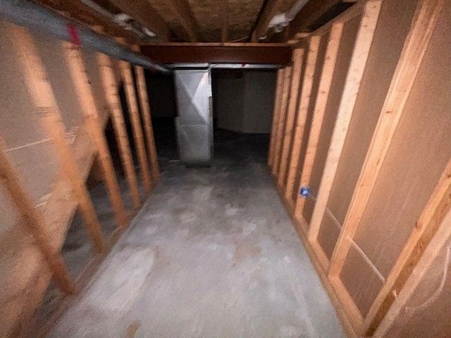 unfinished below grade area featuring heating unit