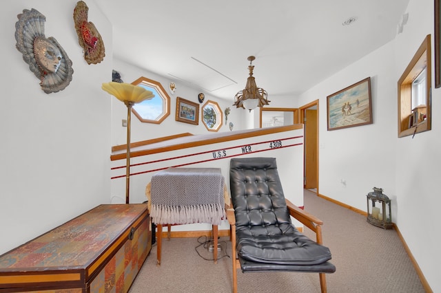 sitting room featuring carpet floors and baseboards