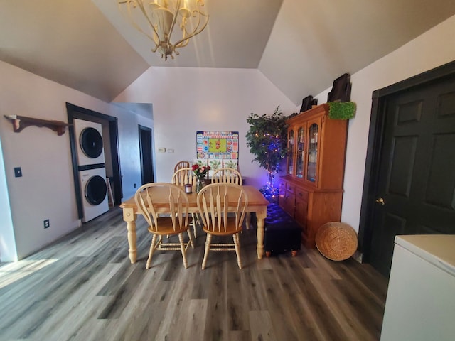 4235 Vine St, Brown City, MI 48416 - dining room featuring stacked washer / drying machine, a chandelier, vaulted ceiling, and wood finished floors