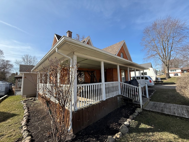 4235 Vine St, Brown City, MI 48416 - view of property exterior featuring a porch, a chimney, and brick siding