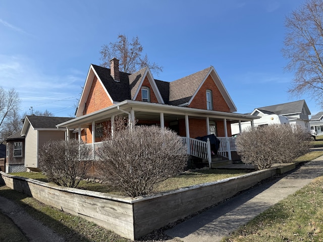 4235 Vine St, Brown City, MI 48416 - view of home's exterior with a porch, a chimney, and a shingled roof