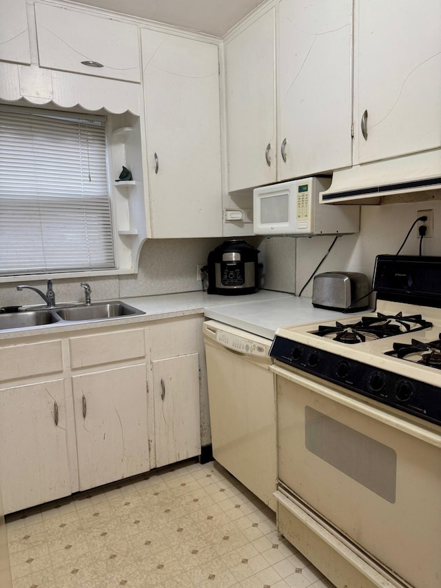 kitchen featuring white appliances, exhaust hood, light flooring, a sink, and light countertops