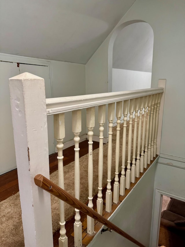 stairs featuring carpet floors and lofted ceiling