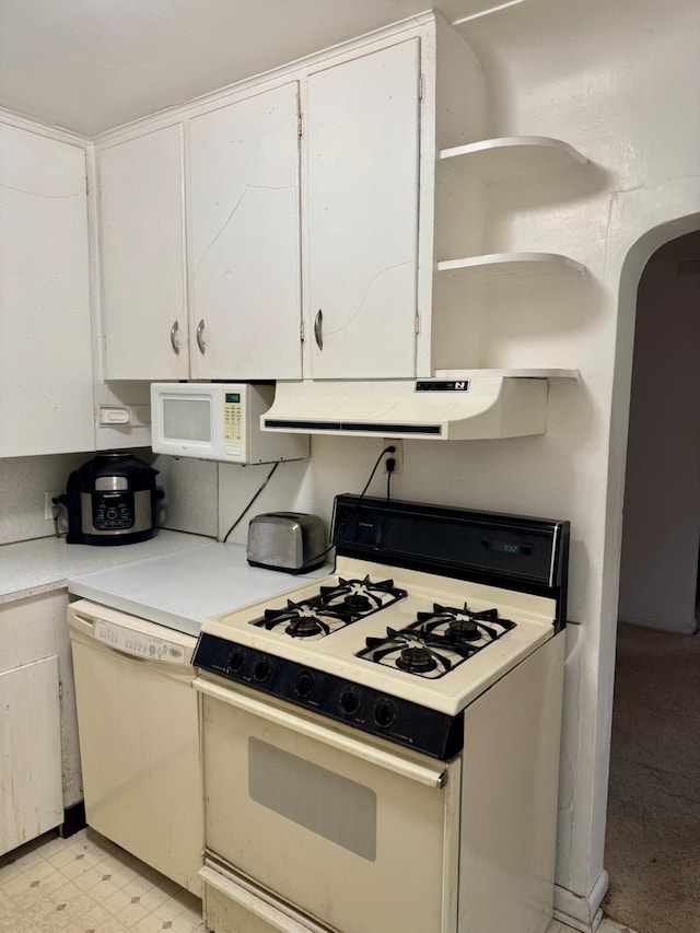 kitchen featuring white appliances, under cabinet range hood, white cabinets, light countertops, and open shelves