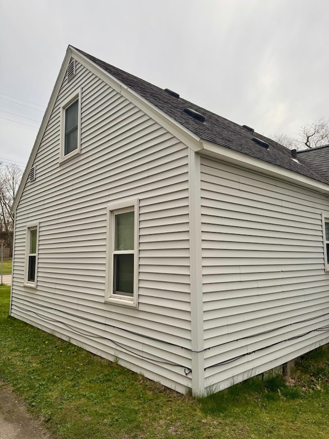 view of home's exterior with a shingled roof
