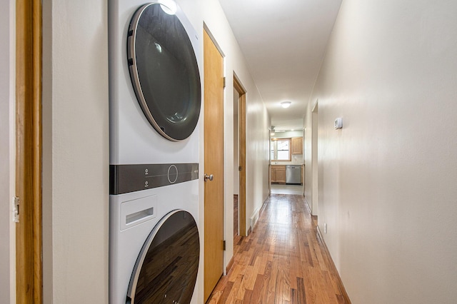 2228 Washington Ave, Saint Joseph, MI 49085 - laundry area featuring stacked washer / dryer, light wood-type flooring, and baseboards
