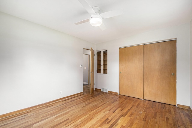 2228 Washington Ave, Saint Joseph, MI 49085 - unfurnished bedroom featuring light wood-style floors, a closet, ceiling fan, and baseboards