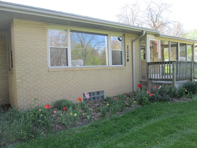 2228 Washington Ave, Saint Joseph, MI 49085 - view of front of home with a sunroom, brick siding, and a front yard