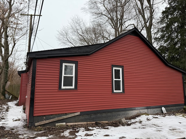 view of snowy exterior with crawl space