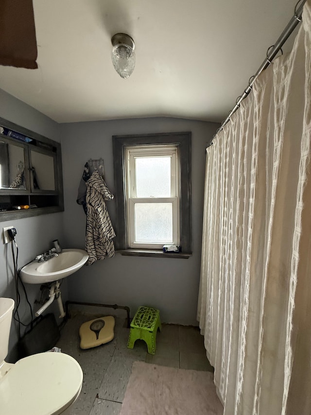 full bath with toilet and tile patterned floors