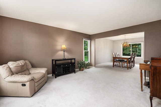 1079 Trailside Blvd, Wixom, MI 48393 - living room featuring a chandelier, light carpet, and baseboards