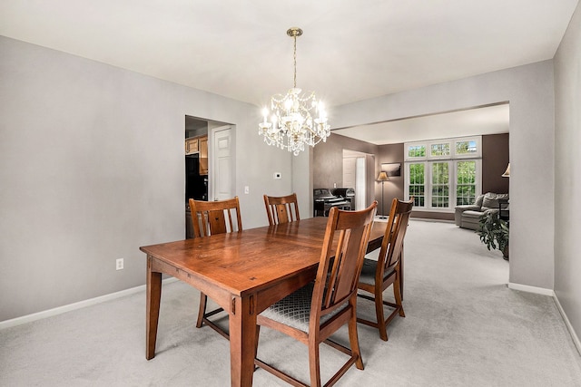 1079 Trailside Blvd, Wixom, MI 48393 - dining space featuring baseboards, light carpet, and a chandelier