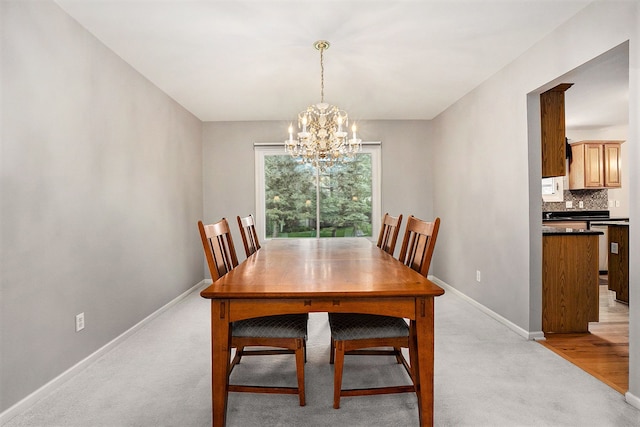 1079 Trailside Blvd, Wixom, MI 48393 - dining room featuring a chandelier, baseboards, and light carpet