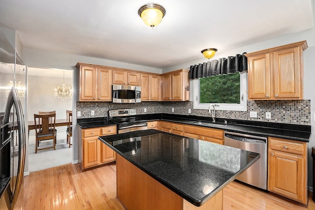 1079 Trailside Blvd, Wixom, MI 48393 - kitchen featuring stainless steel appliances, a sink, light wood-style flooring, and backsplash