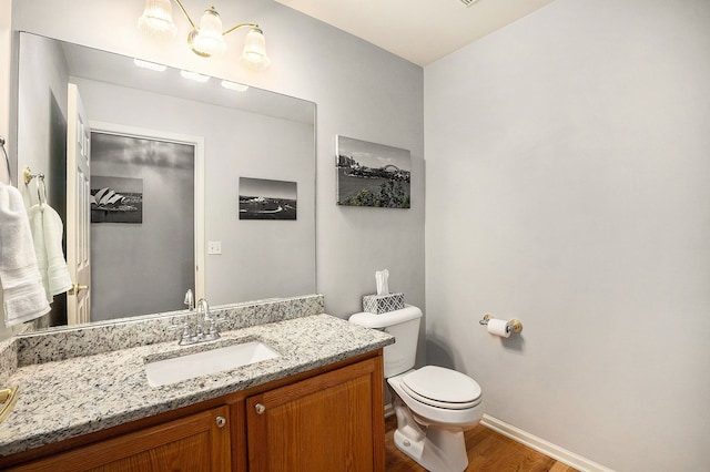 1079 Trailside Blvd, Wixom, MI 48393 - half bathroom with wood finished floors, baseboards, toilet, and vanity