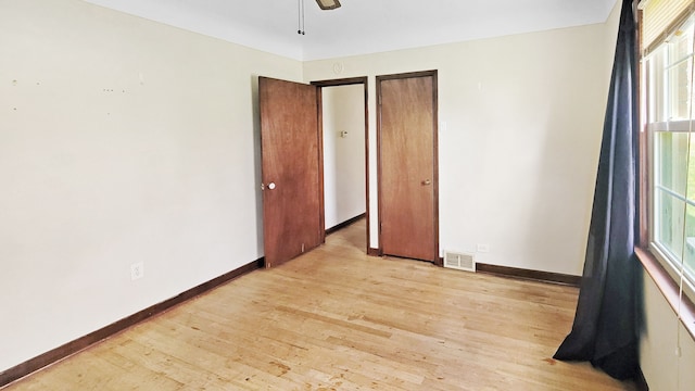 2127 E Coldwater Rd, Flint, MI 48505 - unfurnished bedroom featuring light wood-style flooring and baseboards