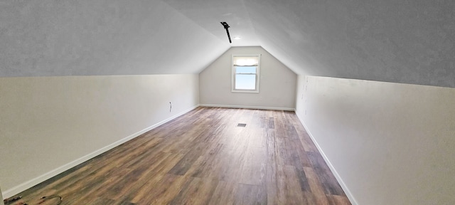 2127 E Coldwater Rd, Flint, MI 48505 - bonus room with wood finished floors, vaulted ceiling, and baseboards