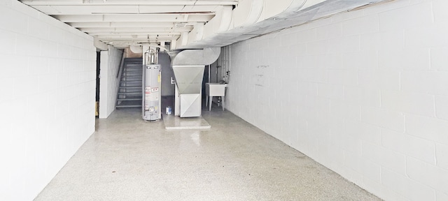2127 E Coldwater Rd, Flint, MI 48505 - unfinished below grade area featuring gas water heater, concrete block wall, and stairway