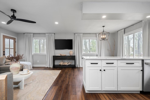 living area featuring a chandelier, recessed lighting, a ceiling fan, dark wood-style floors, and baseboards