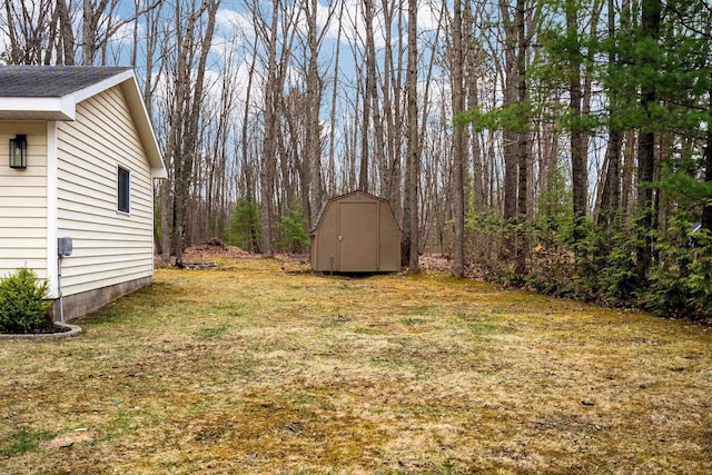 view of grassy yard featuring a storage unit and an outdoor structure