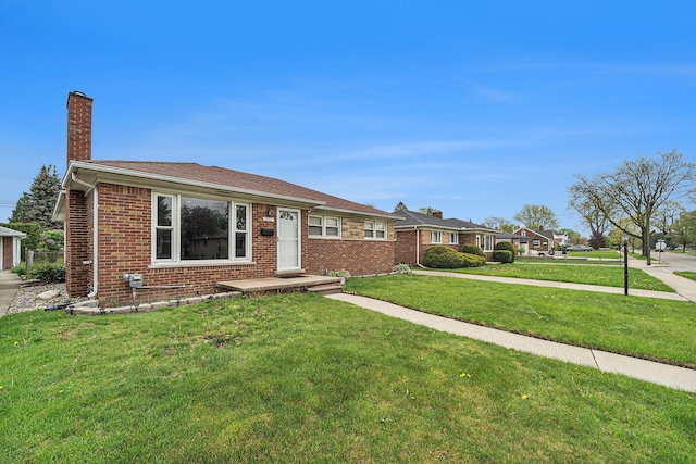 8373 Mckinley, Center Line, MI 48015 - view of front of property featuring a chimney, a front yard, and brick siding