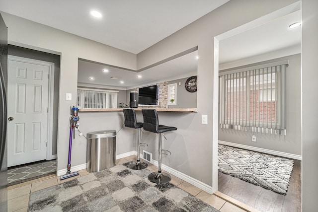 8373 Mckinley, Center Line, MI 48015 - kitchen with recessed lighting, tile patterned floors, baseboards, and a breakfast bar
