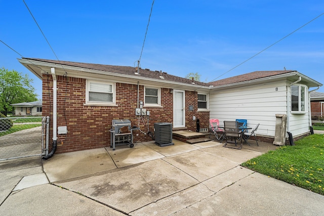 8373 Mckinley, Center Line, MI 48015 - rear view of house featuring cooling unit, a patio area, fence, and brick siding