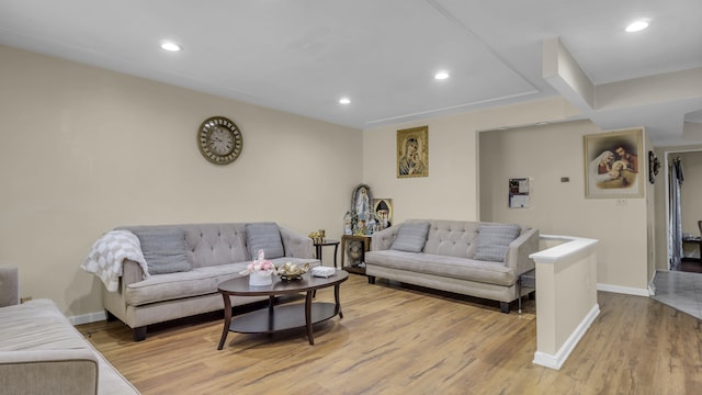 living room featuring light wood-style floors, baseboards, and recessed lighting