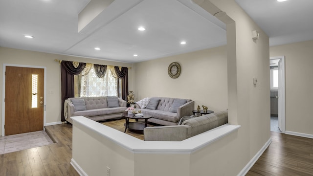 living room with wood-type flooring, baseboards, and recessed lighting