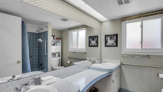 full bath with plenty of natural light, curtained shower, toilet, wallpapered walls, and vanity
