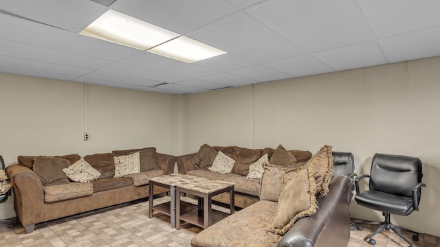 living room with a drop ceiling