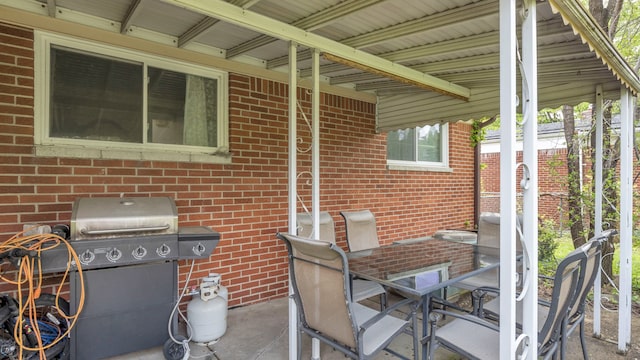 view of patio with a grill and outdoor dining area