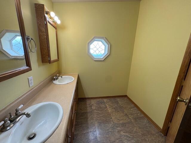 205 Wren Rd, Sturgis, MI 49091 - bathroom featuring healthy amount of natural light, double vanity, and baseboards