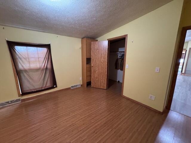 205 Wren Rd, Sturgis, MI 49091 - unfurnished room with wood finished floors, a textured ceiling, and lofted ceiling