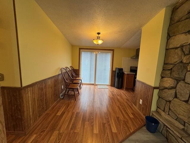 205 Wren Rd, Sturgis, MI 49091 - living area featuring a textured ceiling, wood finished floors, wainscoting, and wood walls