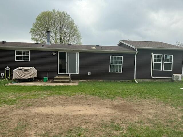 205 Wren Rd, Sturgis, MI 49091 - rear view of property featuring entry steps, a yard, and a cooling unit