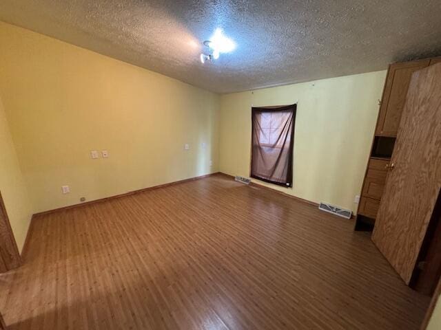 205 Wren Rd, Sturgis, MI 49091 - spare room featuring wood finished floors, a textured ceiling, and baseboards