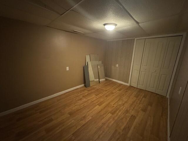 205 Wren Rd, Sturgis, MI 49091 - finished basement with a paneled ceiling, wood finished floors, and baseboards