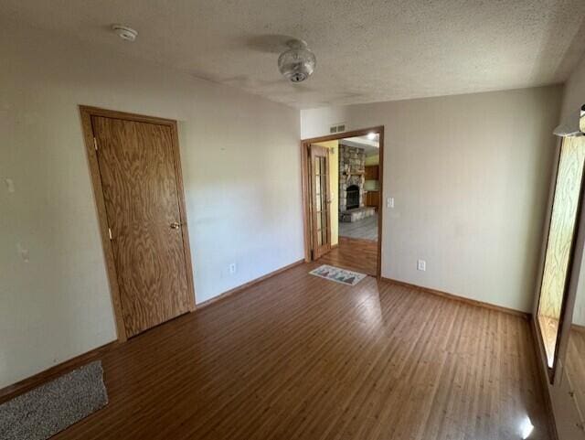 205 Wren Rd, Sturgis, MI 49091 - unfurnished room featuring wood finished floors, baseboards, and a textured ceiling