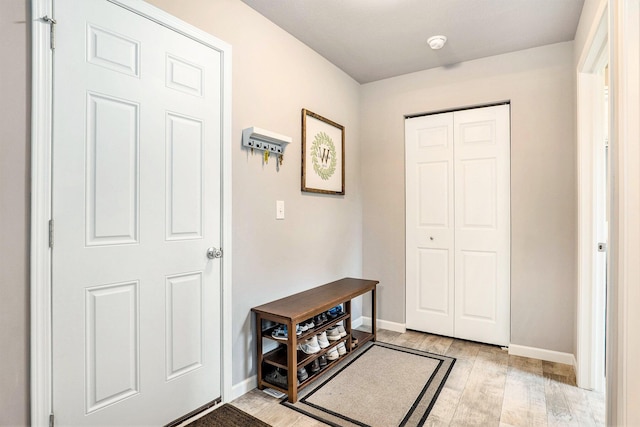 entrance foyer featuring light wood finished floors and baseboards