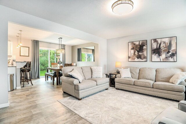 living room with light wood finished floors and baseboards