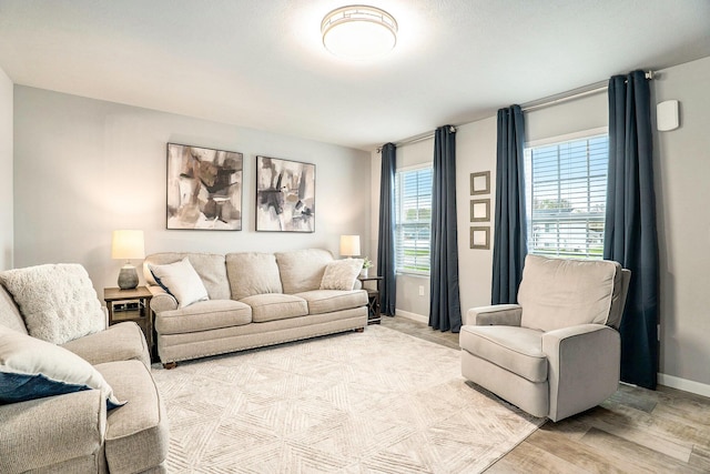 living room featuring light wood-style flooring and baseboards