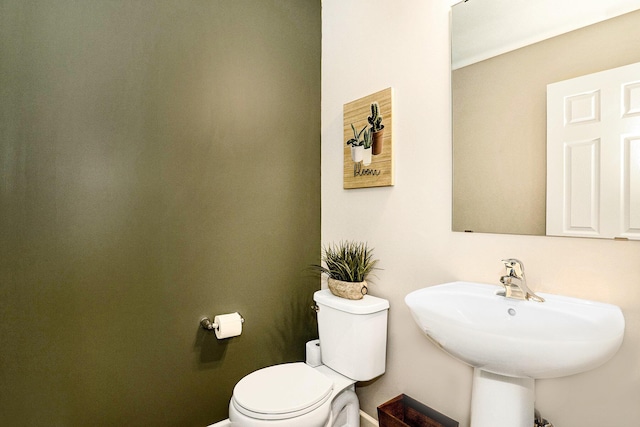 bathroom with toilet and a sink